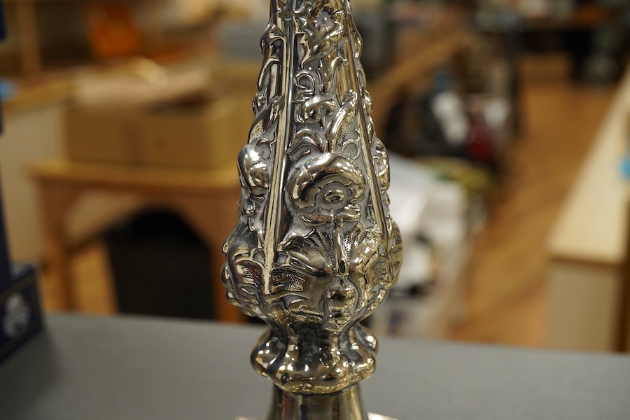 A pair of late Victorian silver candlesticks, with foliate decoration, by Walker & Hall, Sheffield, 1899, height 23cm, weighted.